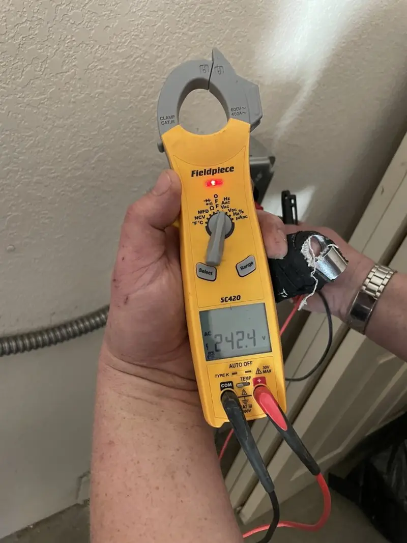Voltage testing with clamp meter during Ceiling Fan Installation in Griswold